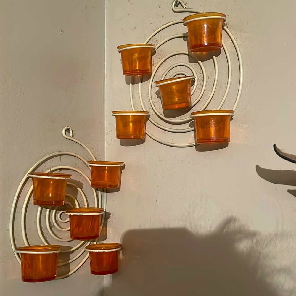 Pair of metal spiral, glass tea light candle wall hanger